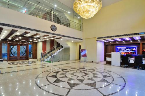 a large lobby with a clock and a dance floor at Crystal Ganga Heights 5 Min from Har Ki Pauri in Haridwār