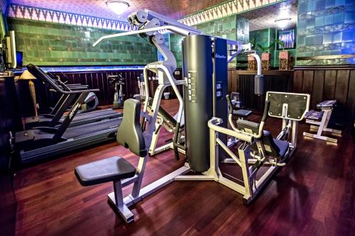 a gym with several treadmills and weights at Art Deco Imperial Hotel in Prague
