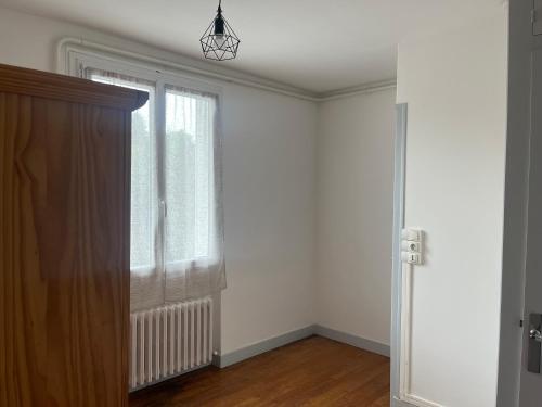 an empty room with a window and a radiator at Maison de ville in Valençay