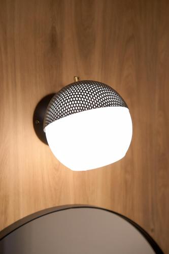 a black and white light fixture on a wooden wall at XANTHI POLIS CITY CENTER with private parking in Xanthi