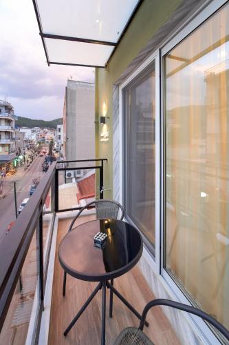 a balcony with a table and chairs on a balcony at XANTHI POLIS CITY CENTER with private parking in Xanthi