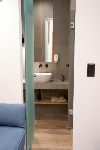 a bathroom with a sink and a mirror at XANTHI POLIS CITY CENTER with private parking in Xanthi