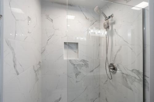 a bathroom with a shower with a glass door at 337 Hale Kamaole in Wailea