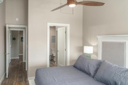 a living room with a blue couch and a ceiling fan at 337 Hale Kamaole in Wailea