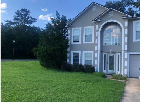 a house with a green lawn in front of it at Avalon Stay 7 nights minimum booking in Jacksonville
