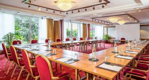 a large conference room with long tables and chairs at Best Western Victor's Residenz-Hotel Rodenhof in Saarbrücken