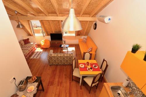 a small living room with a table and a kitchen at Sao Jorge Apartments & Suites in Lisbon