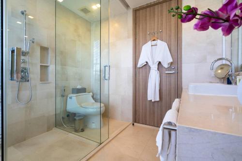 a bathroom with a shower and a toilet and a sink at Baan MaiKhao by CHIWA in Mai Khao Beach
