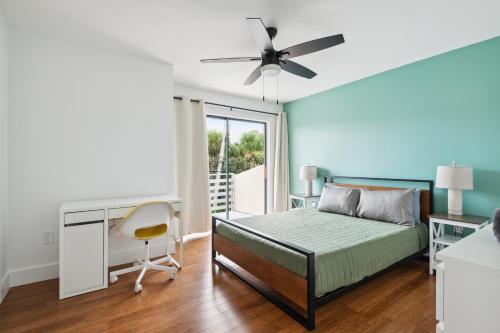 a bedroom with a bed and a desk at Amazing 2 Bedroom Townhouse near beach in Indialantic
