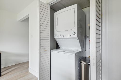 a washer and dryer in a white closet at Amazing 2 Bedroom Townhouse near beach in Indialantic