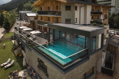 an overhead view of a building with a swimming pool at Hotel Gappmaier in Saalbach Hinterglemm