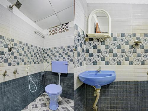 a bathroom with a blue toilet and a sink at Kabas Lodge in Ernakulam