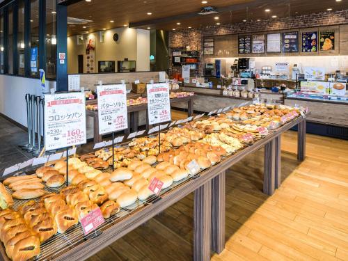 a bakery filled with lots of different types of bread at Vessel Inn Shigamoriyama Station in Moriyama