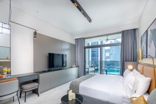 a hotel room with a bed and a television at Bespoke Holiday Homes - Mag 318 Downtown Dubai in Dubai