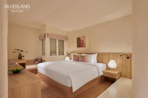 a bedroom with a large white bed and a window at Silverland Bến Thành in Ho Chi Minh City