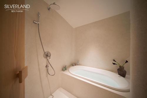 a bathroom with a shower and a bath tub at Silverland Bến Thành in Ho Chi Minh City