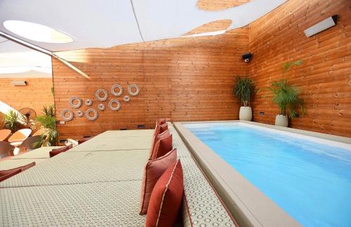 a swimming pool in a room with a brick wall at Castillo Tel Aviv in Tel Aviv