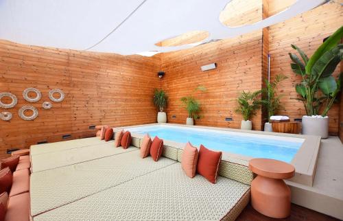 a swimming pool in a room with a brick wall at Castillo Tel Aviv in Tel Aviv