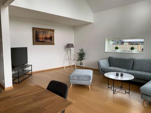 a living room with a couch and a table at Mellby Kite Surf Villa in Mellbystrand