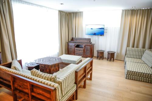 a living room with a couch and a table at Studio Apartments Visit Point in Sarajevo