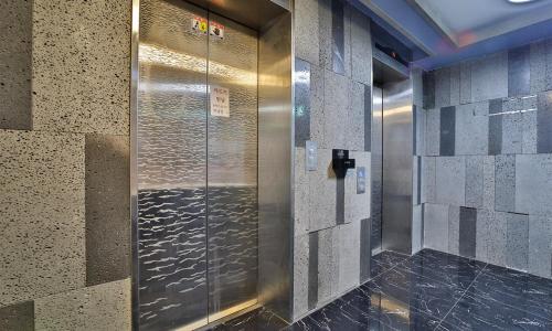 a elevator in a building with a metal door at Changwon Hotel Baba in Changwon