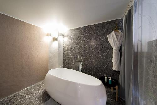 a bathroom with a white tub and a shower at Inn OZZ in Karagandy