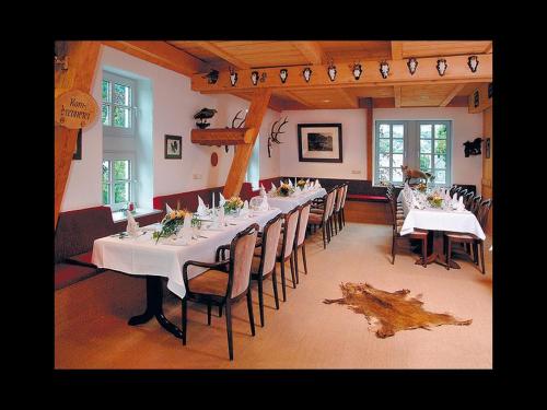a large dining room with a long table and chairs at Gasthof Heimes in Schmallenberg