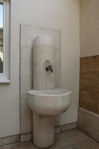 a bathroom with a toilet in a room at Studio Apartments Visit Point in Sarajevo