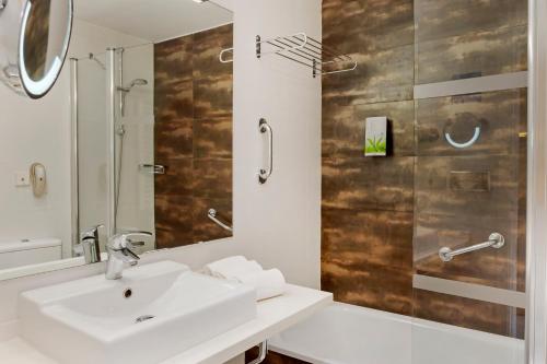 La salle de bains est pourvue d'un lavabo et d'une douche. dans l'établissement Los Amigos Beach Club, à La Cala de Mijas