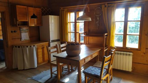 a kitchen with a table and chairs in a room at Dom na Pawlikach in Rzepiska