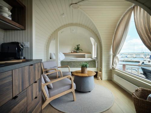 a bedroom with a bed and a table with a chair at Iglupark in Tallinn