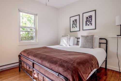 a bedroom with a large bed with white walls at South Boston 1br w building wd nr seaport BOS-913 in Boston