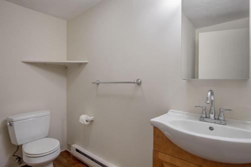 a white bathroom with a toilet and a sink at South Boston 1br w building wd nr seaport BOS-913 in Boston