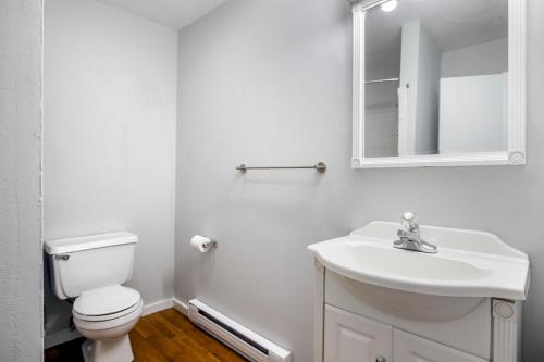 a white bathroom with a toilet and a sink at South Boston 2br w building wd nr seaport BOS-914 in Boston