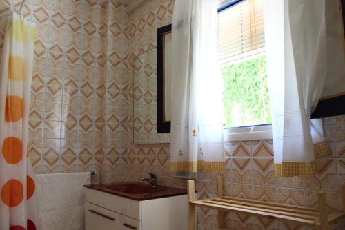 baño con lavabo y ventana en Casa Alcaida, en Quesada