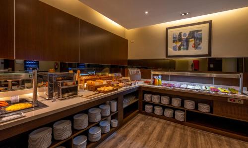 a buffet line in a restaurant with food at Hotel Attica21 Las Rozas in Las Rozas de Madrid