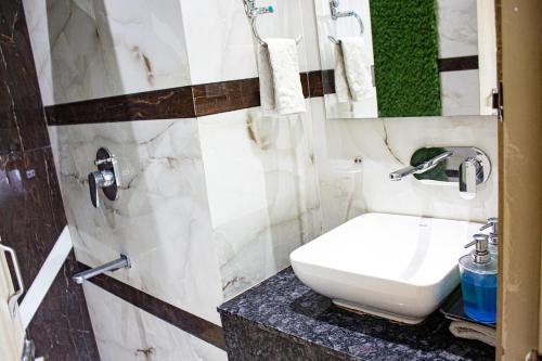 a bathroom with a white toilet and a sink at Hotel Global Inn in Amritsar