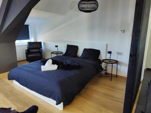 a bedroom with a large bed with a white duck on it at B&B Leopold & Vakantiewongingen in Sint-Truiden