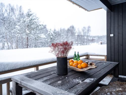 a wooden table with a basket of oranges and bottles at Beautiful apartment - high standard - Geilo centre in Geilo