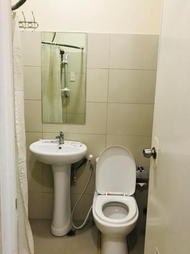 a bathroom with a toilet and a sink at Primavera Residence Silver 3Kates in Cagayan de Oro