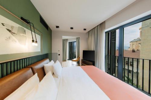 a bedroom with a bed and a balcony at Hotel 21 in Tbilisi City