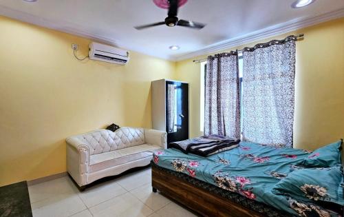 a bedroom with a bed and a couch and a ceiling fan at Gopal Hotel and Palace in Jhunjhunūn