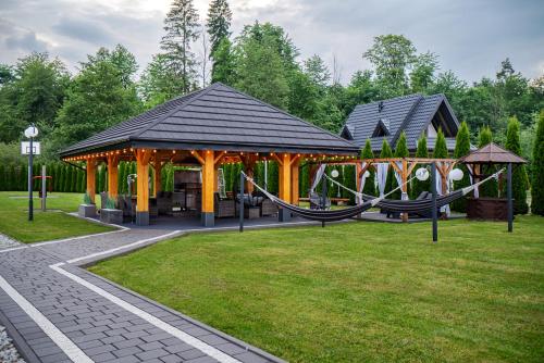 a playground in a park with a gazebo at Parzenica B&B - Wyjątkowa i Jedyna!!! Sprawdź nas a nie pożałujesz! in Białka Tatrzanska