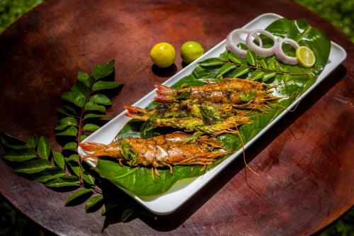 two lobsters on a plate on a wooden table at Sterling Vythiri Wayanad in Wayanad