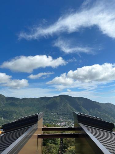 a view from a building with mountains in the background at HAKONE DOMA in Hakone