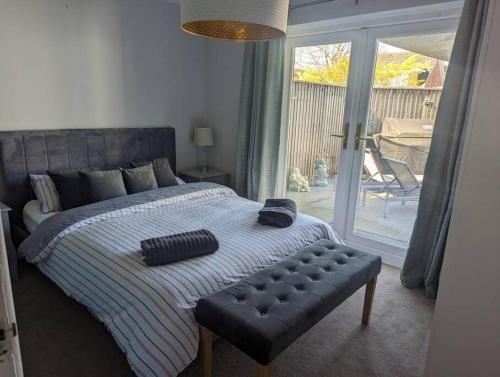 a bedroom with a bed with a ottoman and a window at Apartment in Bournemouth, Dorset in Bournemouth