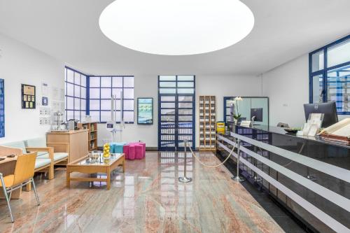 a large room with tables and chairs and a large ceiling at Club Cala Blanca in Taurito