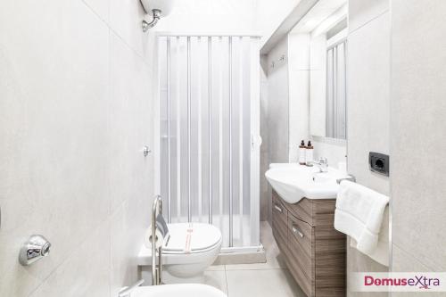 a bathroom with a toilet and a sink and a window at La Casetta agli Orefici By DomusExtra in Naples