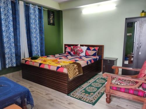 a bedroom with a bed in the middle of a room at Seven Hills Homestay in Kalimpong