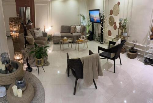 duży salon z kanapą i krzesłami w obiekcie شقة مفروشة في المسعودي w mieście Al-Ajn